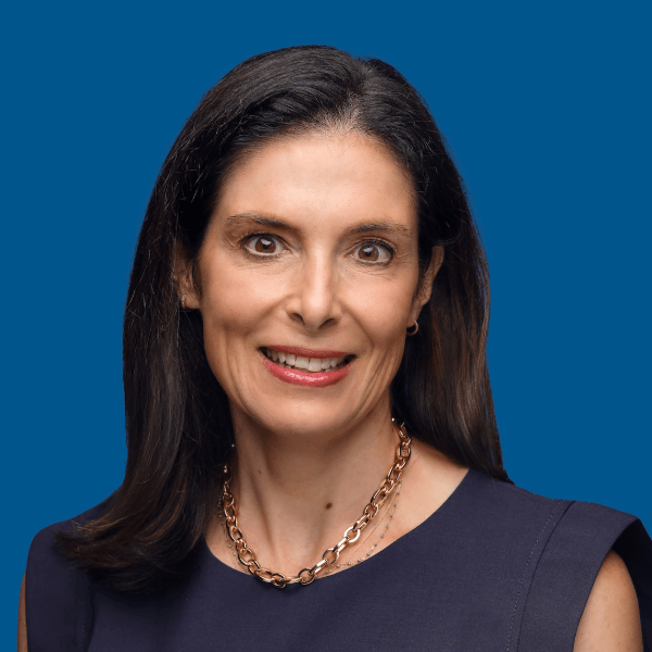 Headshot of Anne Giovanoni, blue background