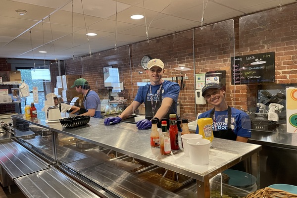 three employees wearing Alkermes in action shirts standing together